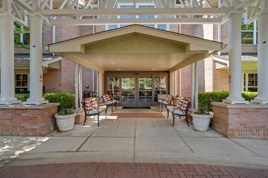 Town Village Vestavia Hills outdoor covered patio with cushioned benches and throw pillows on them.