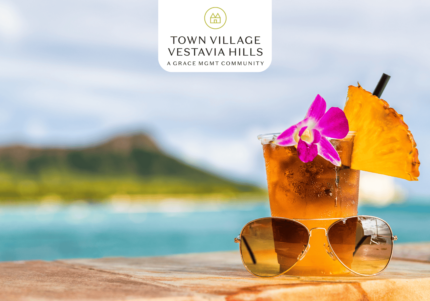 TVVH - Laua Happy Hour - Town Village Vestavia Hills Drink and sunglases on table with island background